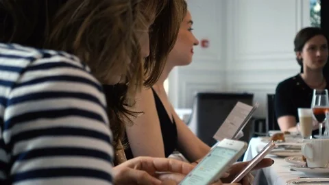 Close Up Of Two Girl At Cafe Using Smartphone Stock-Footage 76484815