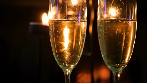 Close up Two glasses of champagne, fireplace in the background Stock Footage 99098884