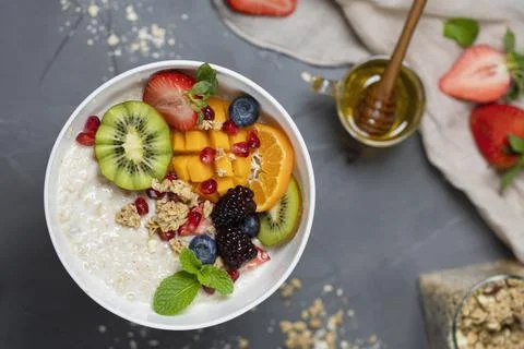 Close up two glasses of chia pudding decorated with fresh baby figs with spoon Stock Photos