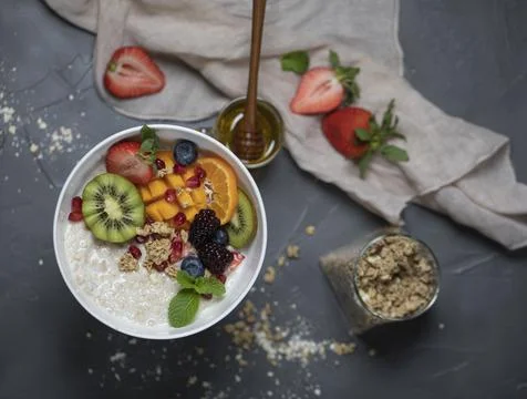 Close up two glasses of chia pudding decorated with fresh baby figs with spoon Stock Photos