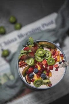 Close up two glasses of chia pudding decorated with fresh baby figs with spoon Stock Photos