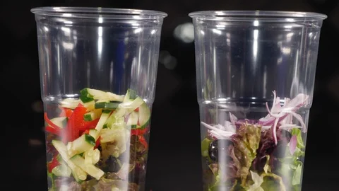 Close-up of two glasses in which fresh salads with two sauces. Stock Footage 128293932