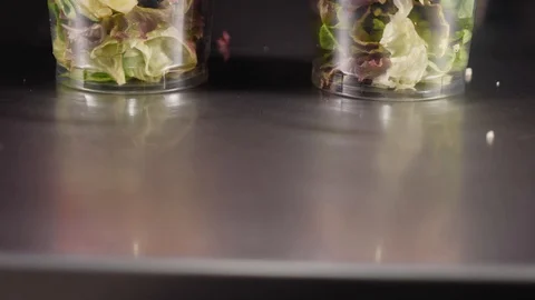 Close-up of two glasses in which fresh salads with two sauces. Stock Footage 128294245