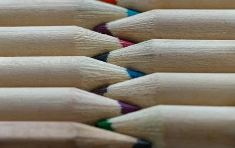 Close-up of Two groups brown crayons are sharp tips and facing collide in a.. Stock Photos