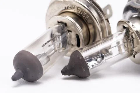 Close-up of Two Halogen Car Headlight Bulbs with Silver Base and Clear Glass. Stock Photos