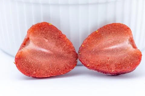 Close-up of two halved strawberries, showcasing their vibrant red interior .. Stock Photos