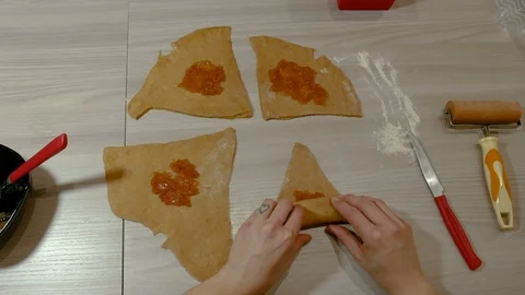Close-up of two hand are preparing some croissants with jam Video stock 87614737