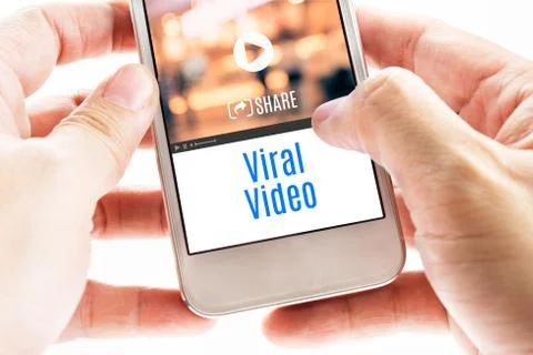 Close up Two hand holding smart phone with Viral Video word and icons, Digita Foto stock