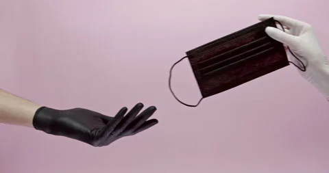 Close up of two hands in black and white gloves sharing with medical protective Stock Footage 146395251