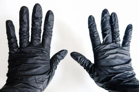 Close up two hands in black gloves on a white background. Stop virus spreading Stock Photos
