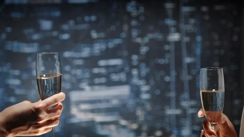 Close up of two hands with bocals of champagne making cheers and then drinking Stock-Footage 112948846