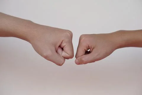 Close up  two hands bump their fists together Stock Photos