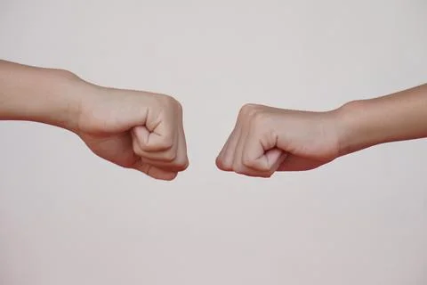 Close up  two hands bump their fists together for greeting. Concept, Body langua Stock Photos