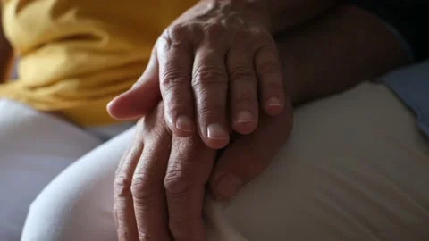 Close up of two hands holding each other together at home taking care - senior a Stock Footage 171896290