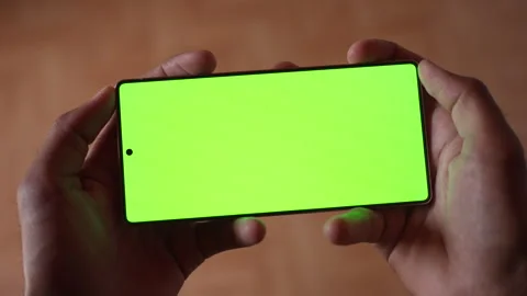 Close-up of Two Hands Holding Smartphone with Green Screen Mockup Chroma Key. Stock Footage 339087885