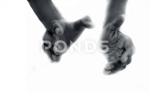 Close up of two hands imagery trying to help the one in need. Stock Photos