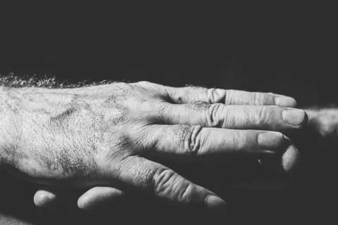 Close-up of two hands lying relaxed on top of each other Foto stock