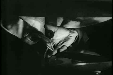 Close-up of two hands passing folded paper under table 스톡 동영상 11352376