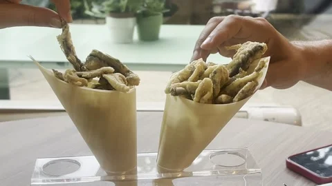 Close-Up of Two Hands Reaching for Fish Fast Food in Paper Bags Stock Footage 319037499