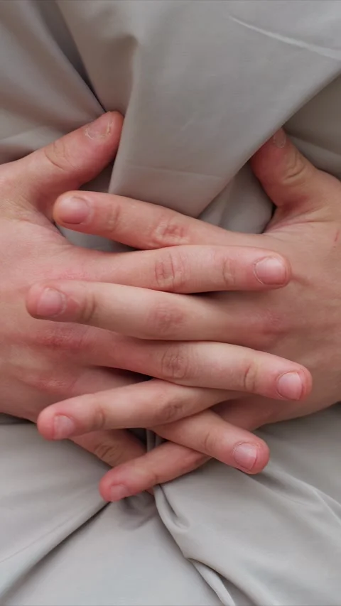 Close up of two hands with red marks on white fabric showing subtle movements Stock Footage 345542879