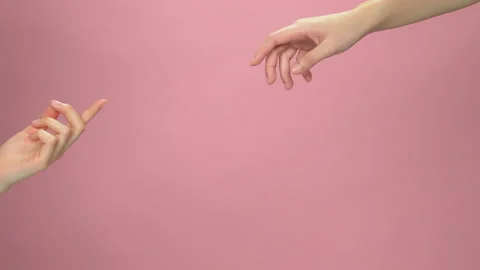 Close up of two hands touch the fingertips on light pink background. 스톡 동영상 153972388