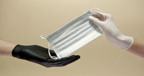 Close up of two hands in white and black medical gloves giving protective face Stock Footage 146394248