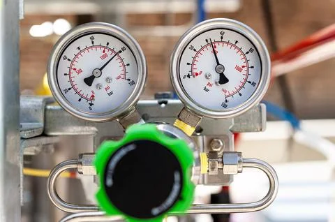 Close-up of two identical high-pressure gauges mounted side-by-side Stock Photos