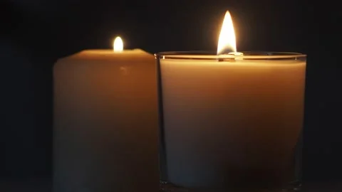 Close Up Of Two Isolated Candles On A Dark Background, UK Stock Footage 154653376