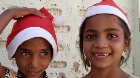 Close up of two kid sisters with Santa hats smiling  Stock Footage 69883371