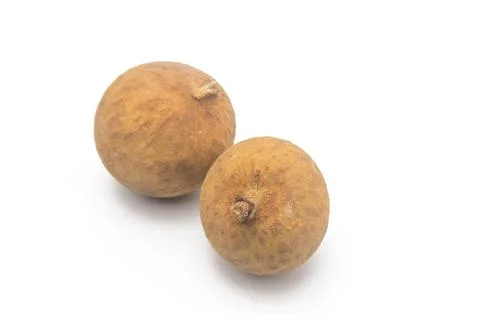 Close-up of two longans on a white background from the middle. Foto stock