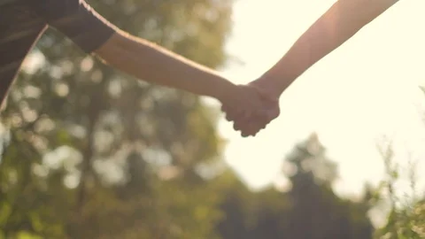 Close up of two lovers dividing hands Stock Footage 92876424