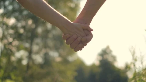 Close up of two lovers joining hands Stock Footage 92876427