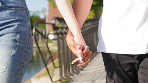 Close up of two lovers joining hands. Detail silhouette of man and woman holding Stock Footage 116666424
