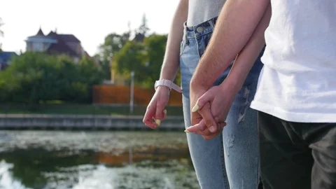 Close up of two lovers joining hands. Detail silhouette of man and woman holding Stock Footage 116666548