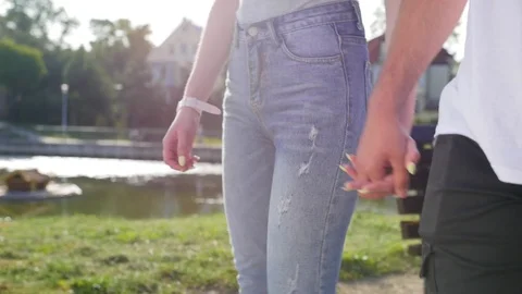 Close up of two lovers joining hands. Detail silhouette of man and woman holding Stock Footage 116667995