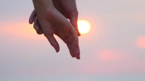 Close up of two lovers joining hands. Man and woman holding hands over the Stock Footage 138608519