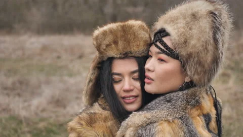 Close-up of two loving Asian young women in ethnic clothes embracing posing in Stock Footage 151709968