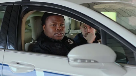 Close up two men cops sitting in patrol car accepting emergence call enforcement Stock Footage 112954185