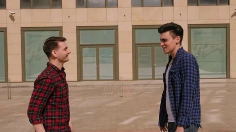 Close-up of two men greeting on the street, they clap each other on the palm. Stock Footage 145868253