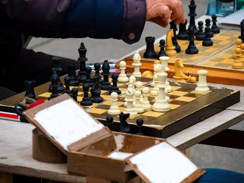 Close-up of two men playing chess on the street due corana pandemic Stock Photos