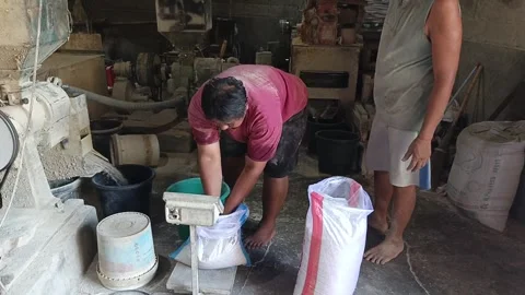 Close Up Two Men Rice Mill Workers Weighing And Packing Grain Bag Видео 345502597