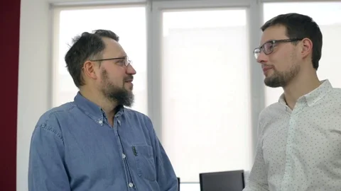 Close up of two men talking in office Stock Footage 97351762