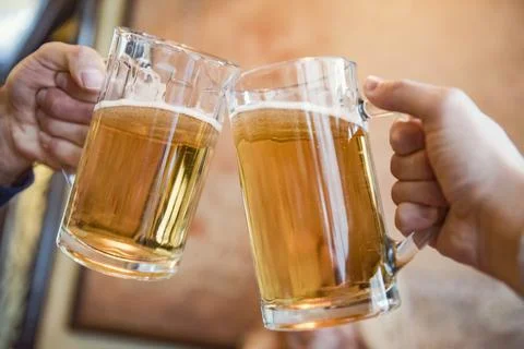 Close-up of two men toasting with beer Foto stock