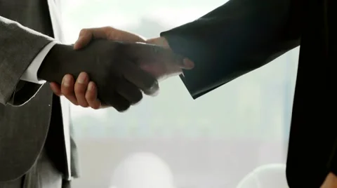 Close up Two multiethnic business partner shake hands when meeting in front of Video stock 68680810