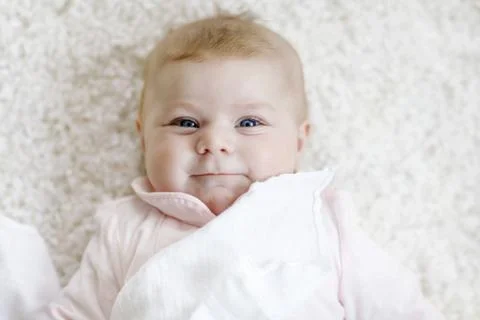 Close-up of a two or three months old baby girl with blue eyes. Newborn child Stock Photos
