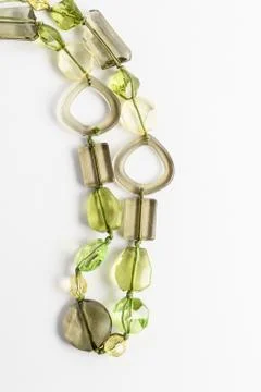 Close up of two parallel lines of green beads isolated on white background Stockfoto's