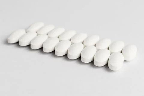 Close up of two parallel lines on white pills on white background 库存照片