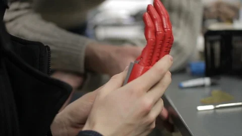 Close up of two people discussing bionic hand. Stock Footage 90277865