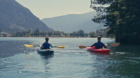 Close Up Two People on Kayaks on River in Oregon Washington Columbia Gorge Stock Footage 280702210