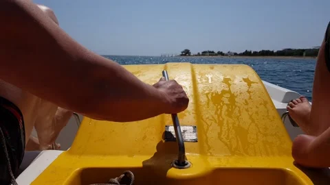 Close up of two people using pedal boat on summer vacation Stock Footage 169158039